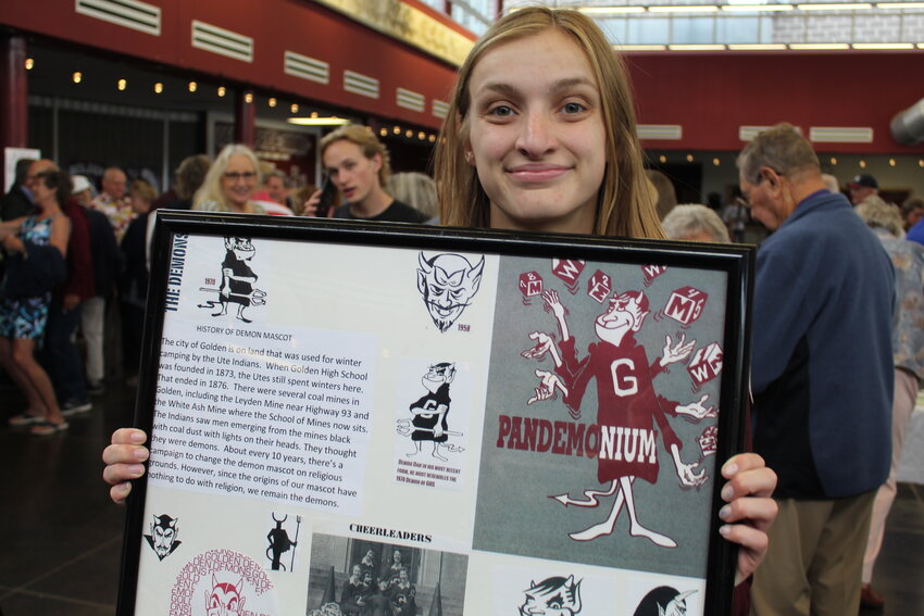 During Golden High School's 150th anniversary celebration on June 4, Class of 2018 graduate Emmy Adams shows off a historical display she made when she was still a student. Adams made several of these displays, and donated some of them to the school when she graduated.